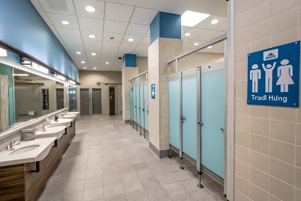 Modern restroom area with sinks and stalls.