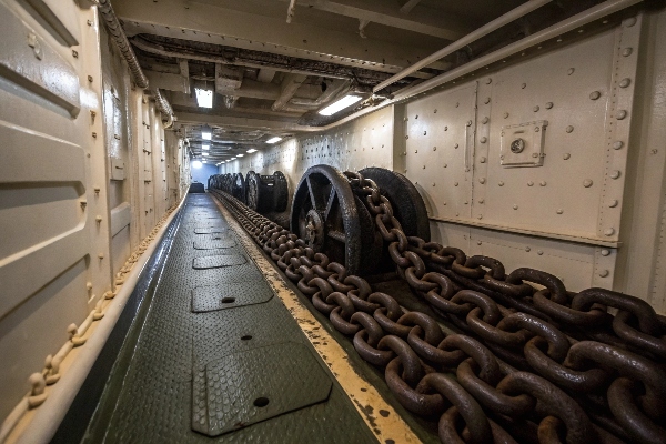 Ship anchor chains stored in a designated chain locker area.