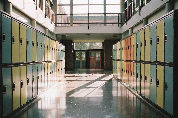 School lockers in a bright hallway, vibrant colors and natural light.