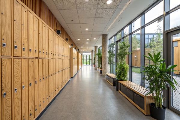 Wooden lockers in a modern hallway with natural light and plants.