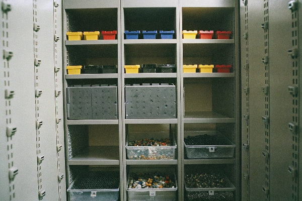 Organized storage shelves with bins and compartments for small items.