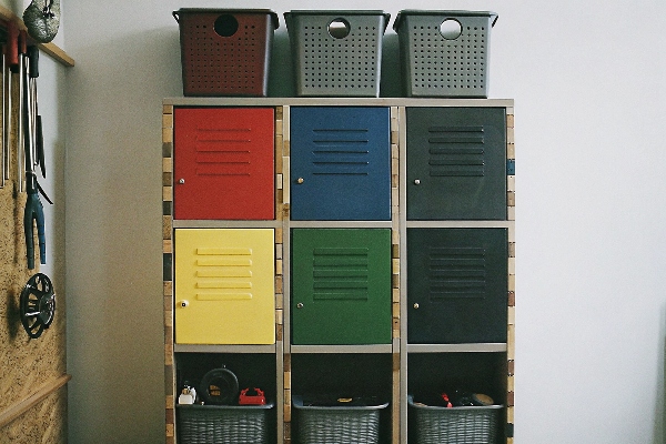 Colorful lockers with storage baskets on top and open shelves below.