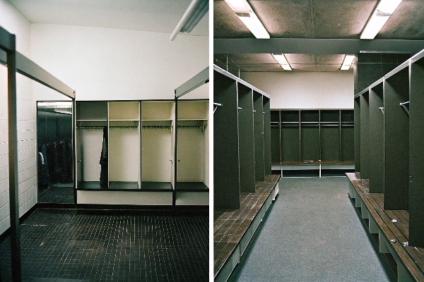 Spacious locker room with open compartments and wooden benches.