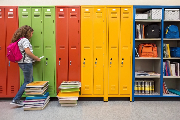 Colorful lockers with a student organizing books.