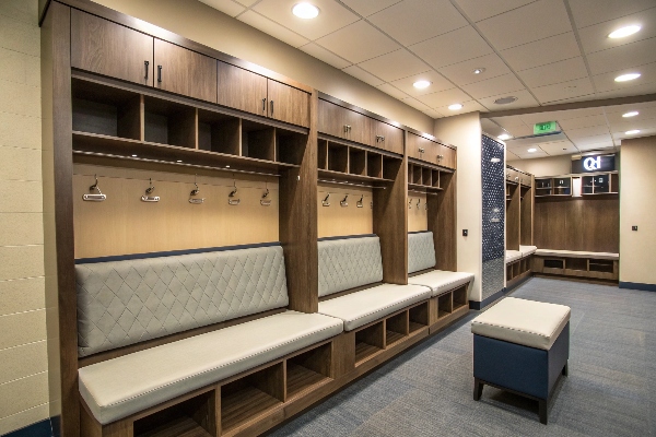 Locker room with wooden lockers and cushioned seating