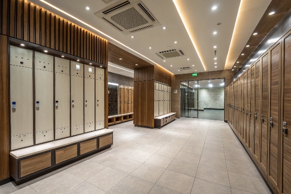 Locker room with wooden and beige lockers and seating