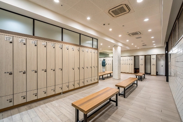 Modern locker room with wooden benches and lockers