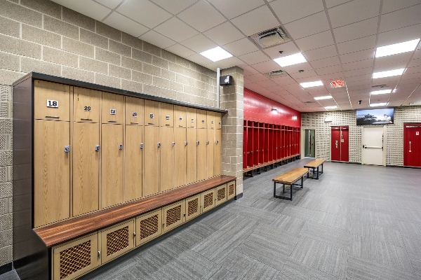 Locker room with wooden lockers and red accents