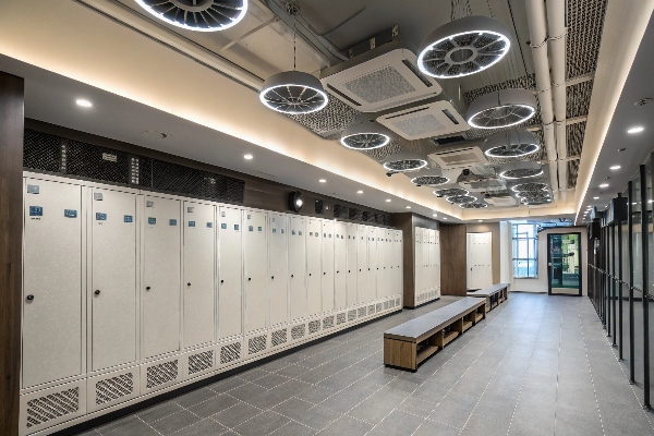 Locker room with white lockers and modern lighting