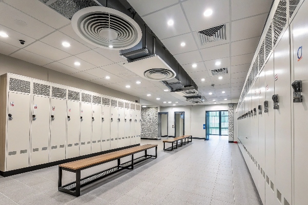 Locker room with light-colored lockers and benches