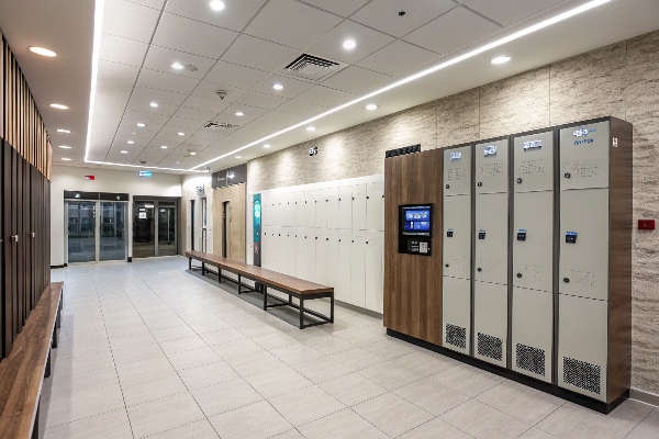 Locker room with electronic lockers and wooden benches