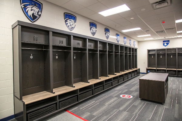 Locker room with team logos and wooden lockers