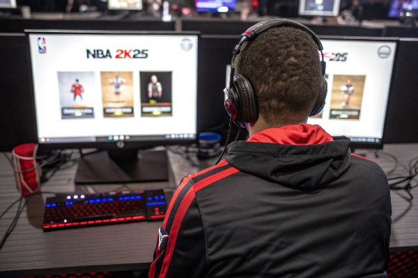 Person playing NBA 2K25 in a gaming tournament