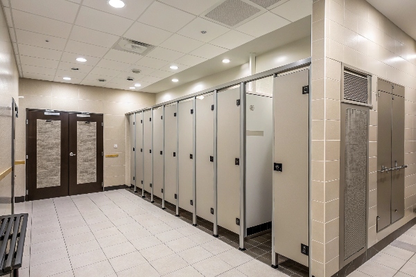 Modern public restroom with clean stalls and tiled flooring